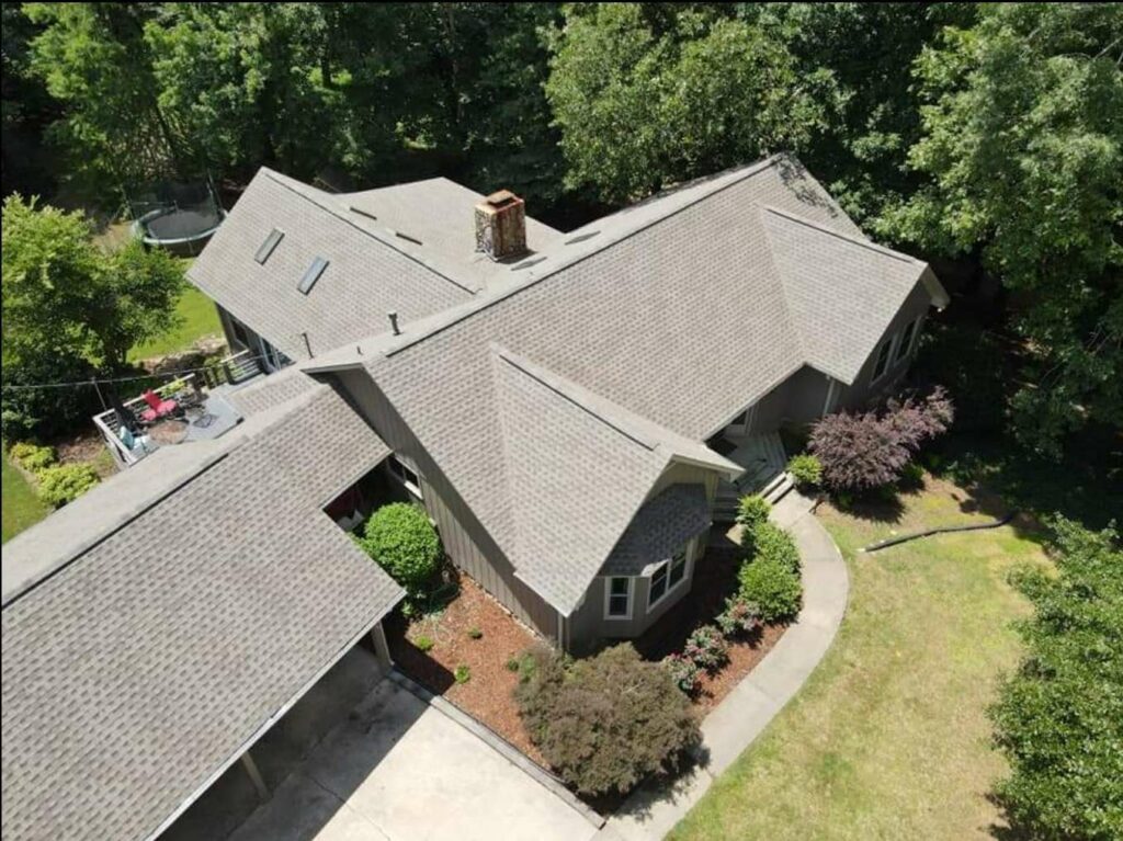 aerial view of home with asphalt roof shingles